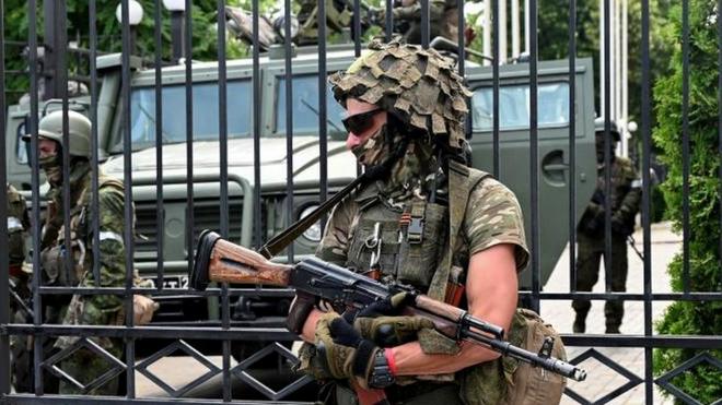 Fighters of Wagner private mercenary group stand guard outside the headquarters of the Southern Military District in the city of Rostov-on-Don, Russia, June 24, 2023.