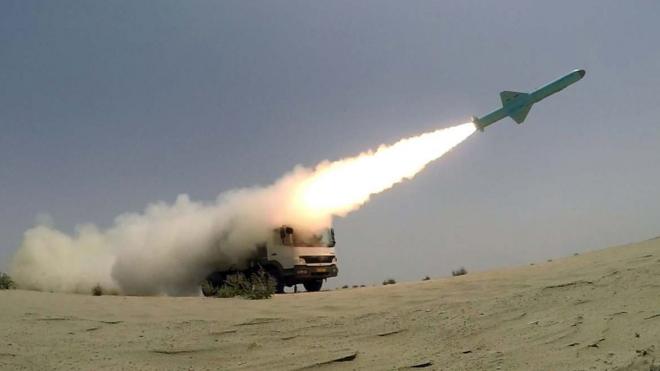 A handout photo shows a missile being fired from a mobile launch vehicle during an Iranian military exercise in the Gulf of Oman (18 June 2020)