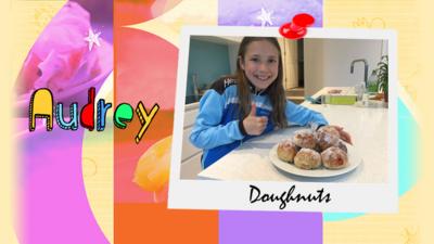 A girl shows a plate of doughnuts that she has made.