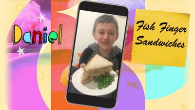 A boy shows a plate of the fish finger sandwiches with Tilly's sharkbite sauce that he has made.