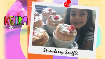 A little girl (Keira) stands in front of a counter top filled with strawberry souffles.