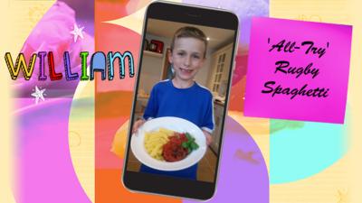 A little boy (William) holding a plateful of 'All-Try' Rugby Spaghetti.