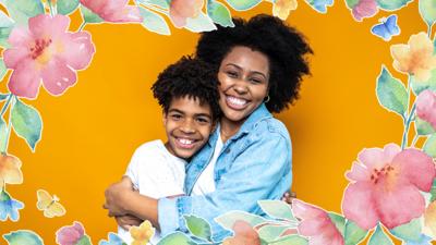 A young black boy is hugging an older, black lady. They are both smiling to camera. A floral frame is around them.
