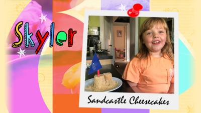 A girl with a plateful of what looks to be sandcastles, with a sign saying 'Sandcastle Cheesecakes.'