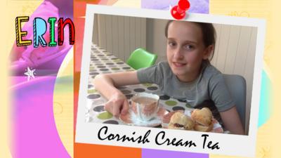 A young girl called Erin shows the camera a plate of Cornish cream scones and a cup of tea.
