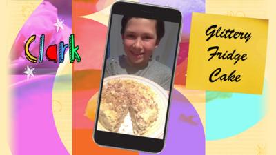 A boy called Clark holding a plate of glitter fridge cake.