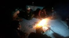 Pakistani soldiers killing time by the bonfire temperature -18 celcius