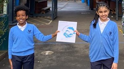 Children holding new school emblem