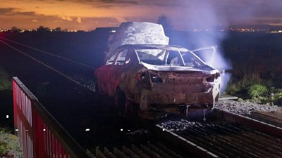 A car was set on fire and abandoned on the railway line between Londonderry and Coleraine