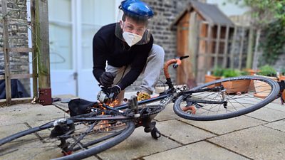 Tom Brada uses an angle grinder to test an anti-theft bike lock device