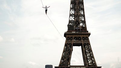 Slackliner Nathan Paulin walking in front of Eiffel Tower