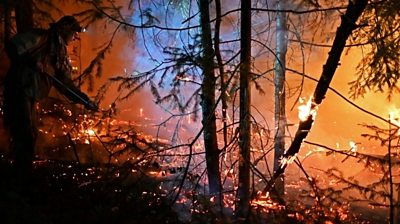 Volunteer works on wildfire in Russia in 2021