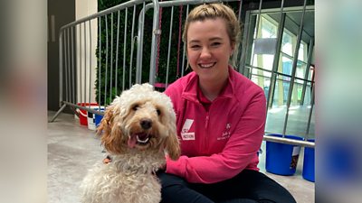 Jodie Evans and a dog at Puppy Petting session at Loughborough University