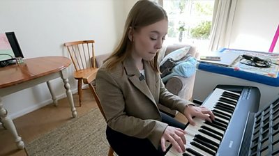Anastasia playing the piano in her new home