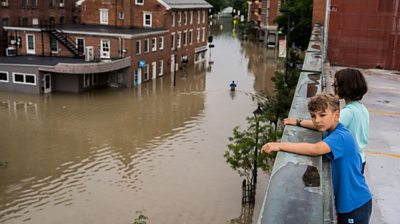 Child looking over flooded city