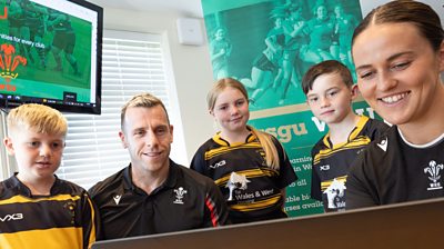 Wales players Gareth Davies (second R) and Ffion Lewis with young players at the DYSGU WRU' launch
