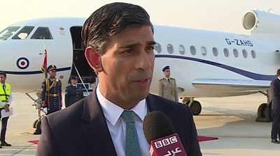 Prime Minister Rishi Sunak speaking in front of a jet plane in Cairo