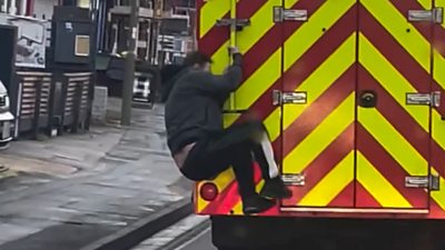Man jumps on back of fire engine
