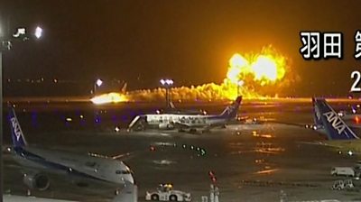 Trail of smoke and flames as plane lands on runway