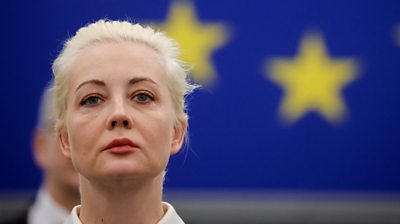 Close of Yulia Navalnaya addressing European Parliament, with EU stars in the background