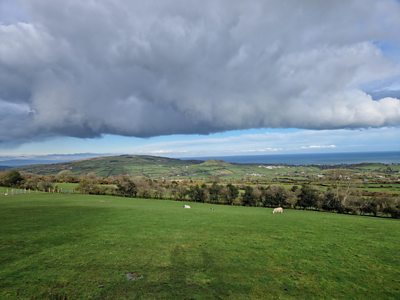 Cloud looming over field