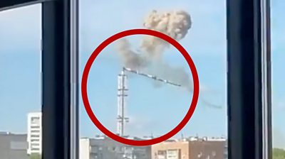 TV tower collapsing with plume of smoke above it