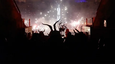 The silhouettes of 'demonic' characters watching a traditional 'correfoc' display in Spain.