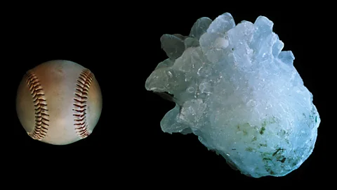 A giant hailstone beside a softball