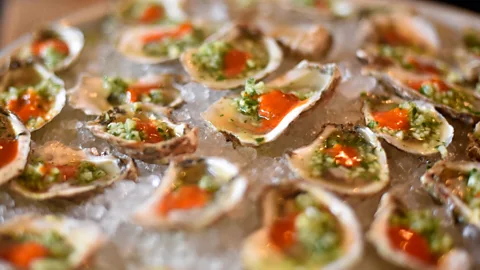 Plate of dressed oysters on ice (Credit: Getty Images)