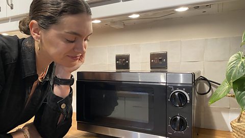 Laura looks at her microwave