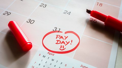 Payday end of month date on calendar with red marker and circled day of salary.