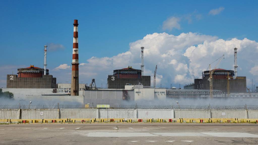 View of Zaporizhzhia nuclear plant showing chimney, buildings and fence