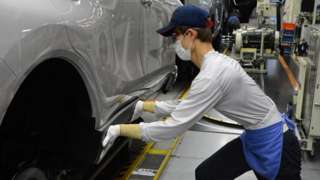 Toyota worker at manufacturing plant in Japan.