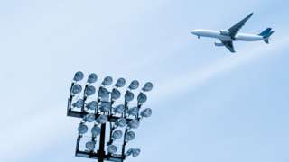 Flight goes over a football stadium