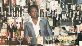Mr Campbell behind the bar of the Iron Master pub with his wife