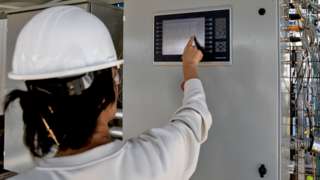 An engineer works on a hybrid direct air carbon capture technology pilot site in Bakersfield, California, USA