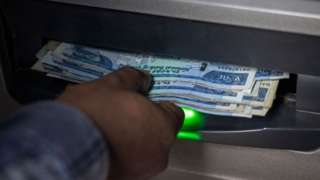A man withdraws Ethiopian Birr from an ATM in Addis Ababa on December 4, 2023.