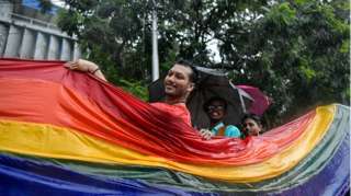 LGBTQ community members celebrate with a rainbow coloured flag as they take part during the pride march to mark the 20th anniversary of the first Pride March in India. Twenty years ago, on July 2, 1999, Kolkata saw 15 people from different corners of India and abroad match their steps together on the streets of Kolkata and begin a new journey of visibility. T
