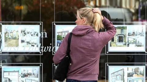 woman looking at houses for sale