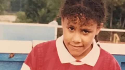 A young Alex Scott wearing Arsenal kit