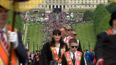 The parade leaves the grounds of Stormont