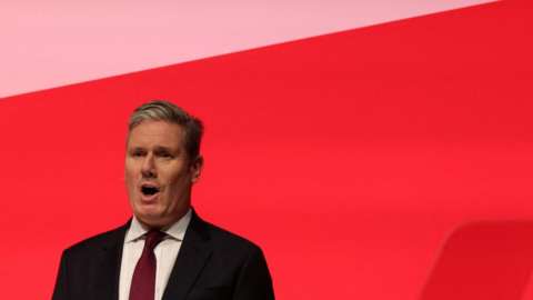 Britain's Labour Party leader Keir Starmer sings the national anthem