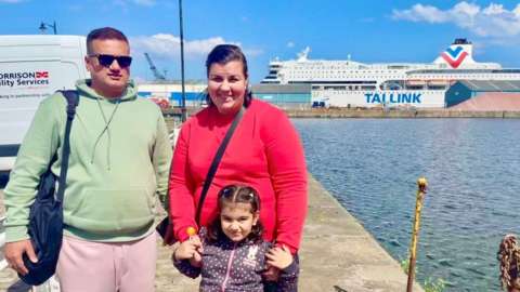 Kashif (44), Tanya (37) and Marcia (5) Munawar with the MS Victoria cruise ship