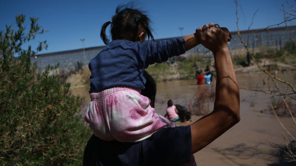 Migrants crossing the US-Mexico border near El Paso, Texas on 12 March