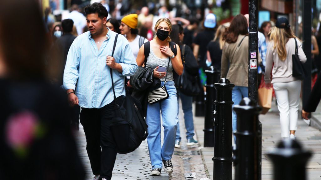 Woman in a mask on a busy London street