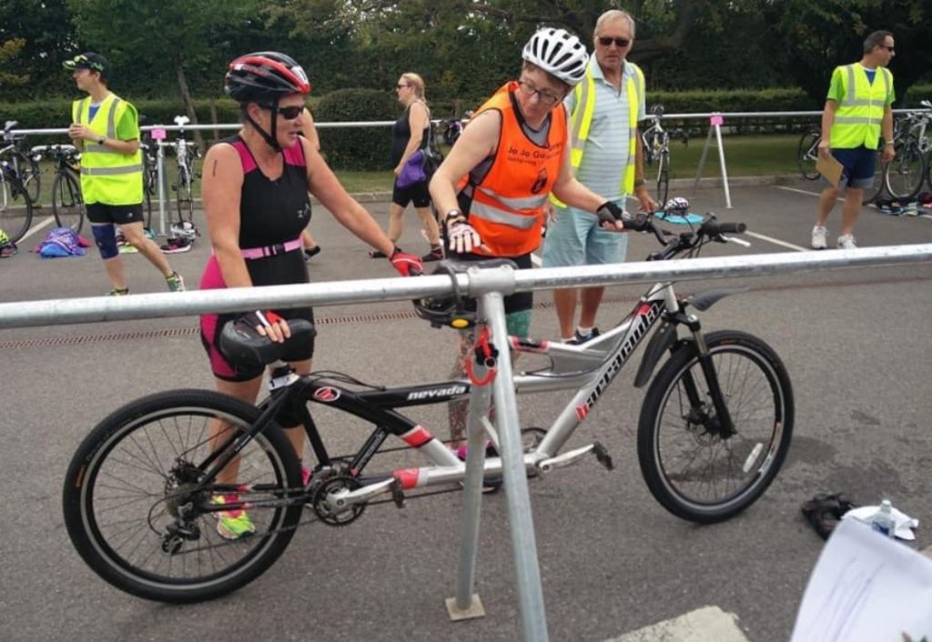 Helen McCann standing by a tandem