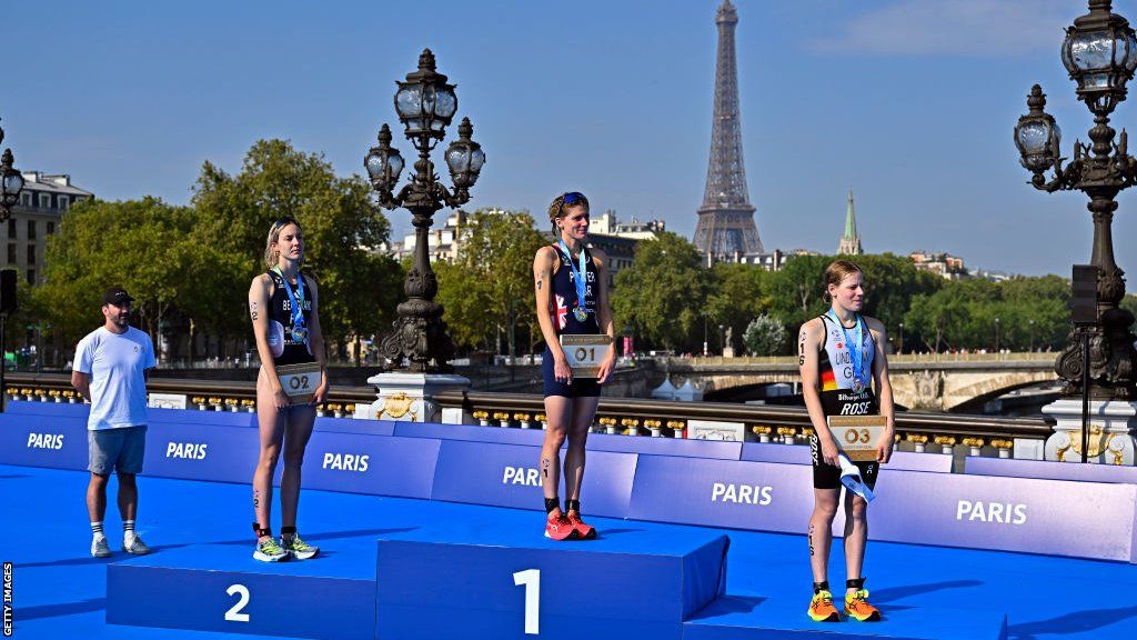 Cassandre Beaugrand of France, Beth Potter of Great Britain and Laura Lindemann of Germany poses with their medals after the Women World Triathlon at Pont Alexandre III on August 17, 2023 in Paris, France.