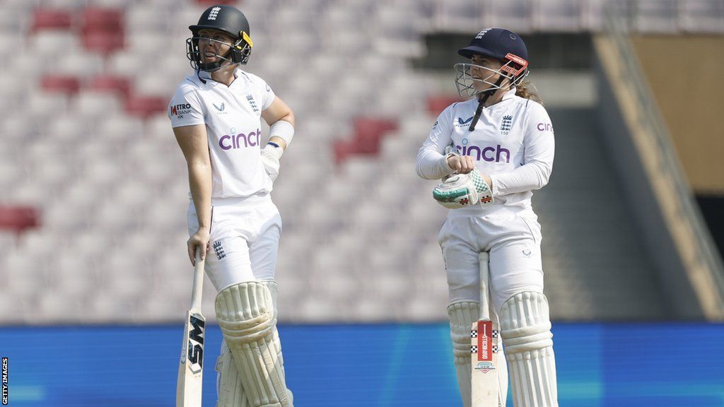 Heather Knight (left) and Tammy Beaumont (right) in discussion while batting v India