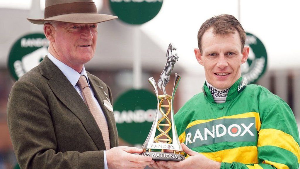 Willie Mullins and Paul Townend holding the Grand National trophy