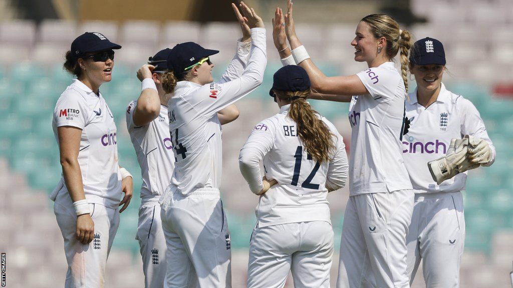 Lauren Bell (middle) celebrates a wicket with England team-mates